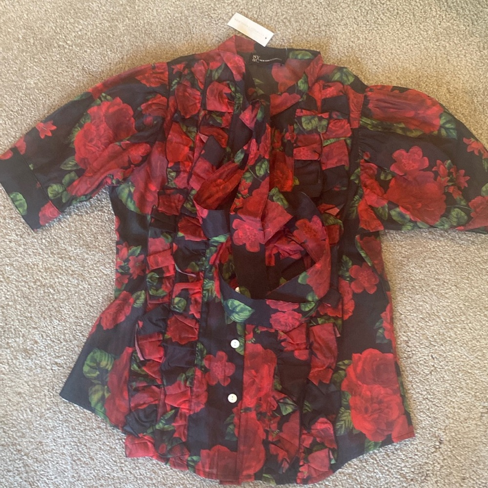 Feminine blouse .size xs ruffle front .short sleeve lightweight material .
